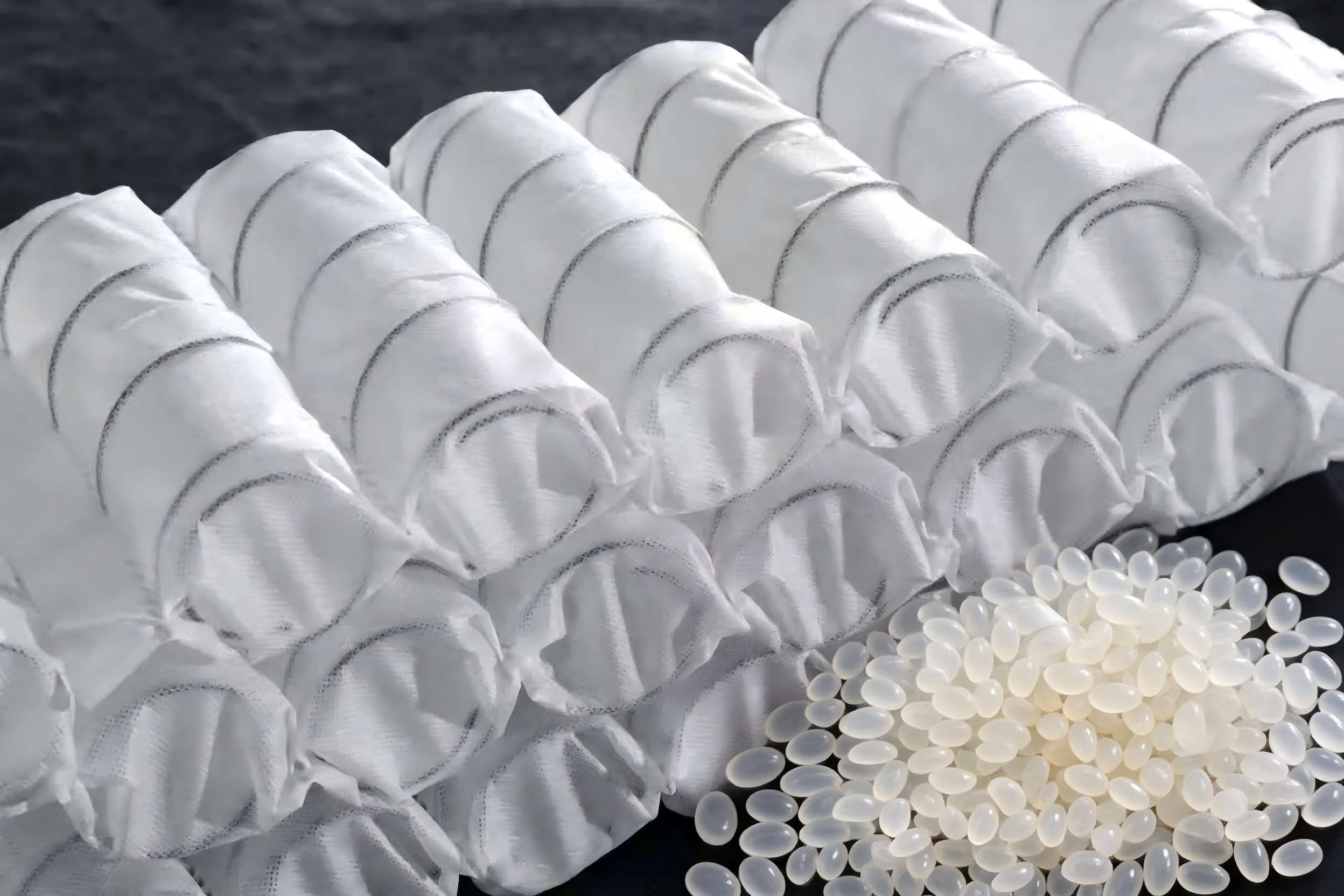 Pocket spring core with hot melt adhesive pellets